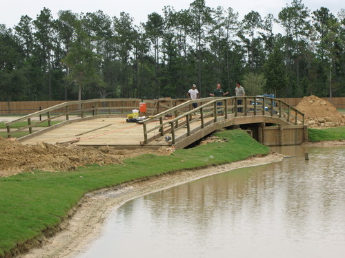 bridge built by lamulle construction over water near grass