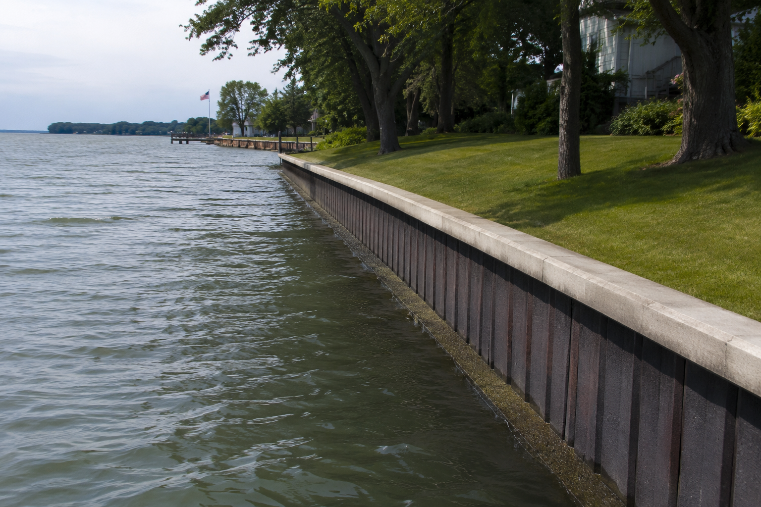 seawall with grass on lake